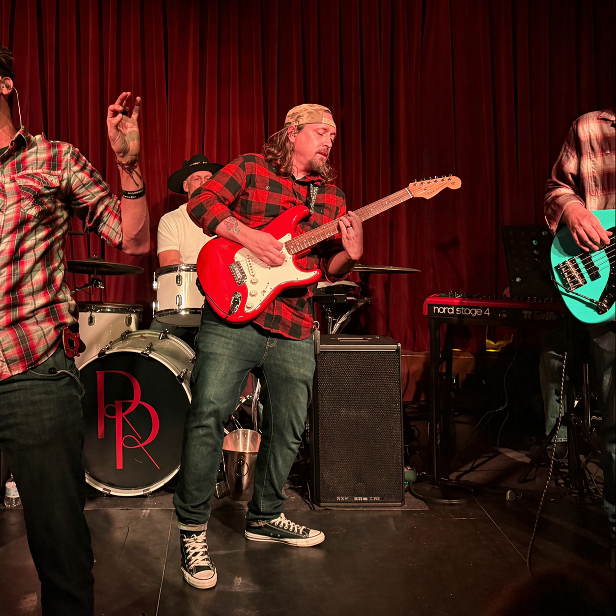 Cade Hagen performing on electric guitar with his band